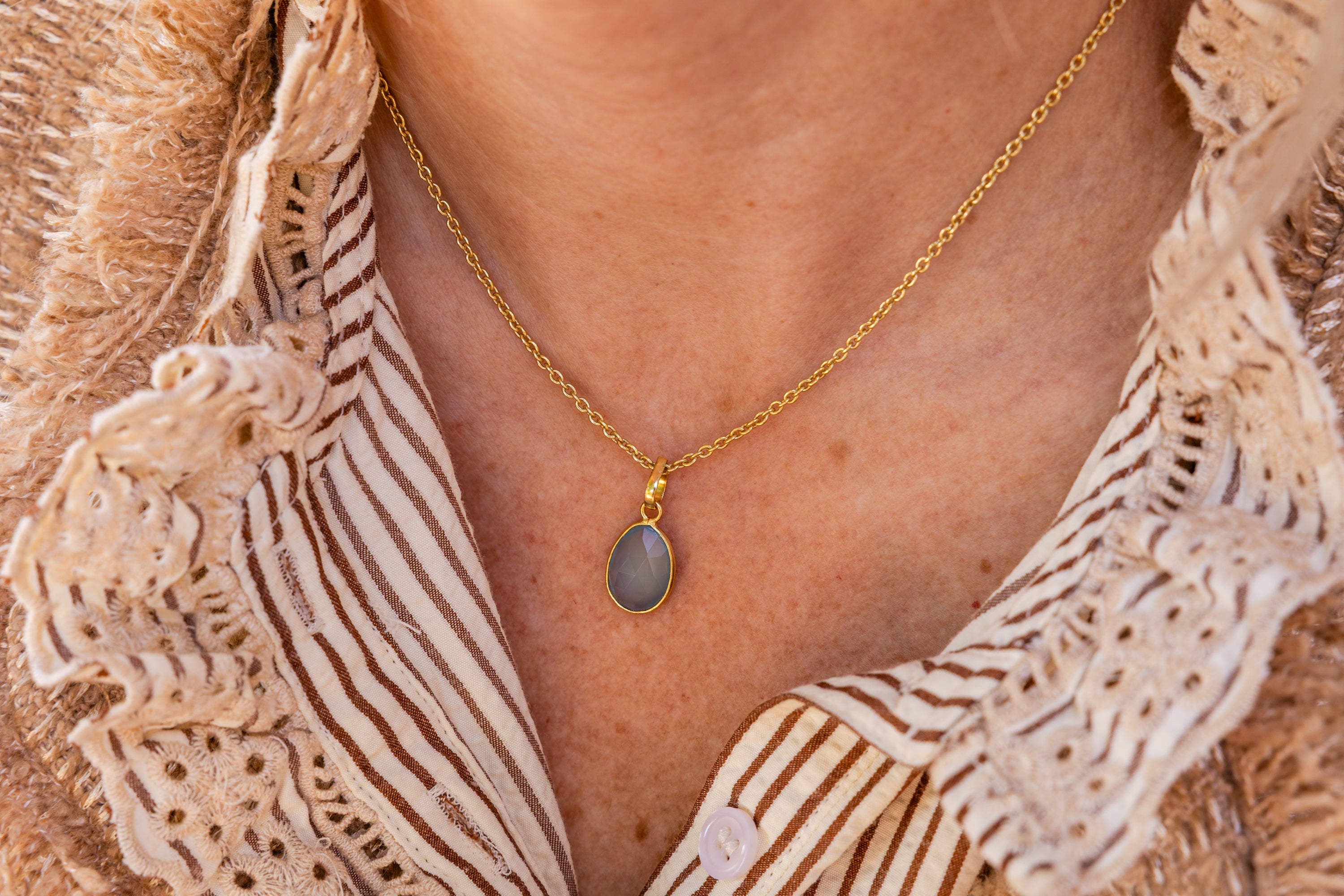 Golden Necklace with Light Blue Onxy Oval Pendant