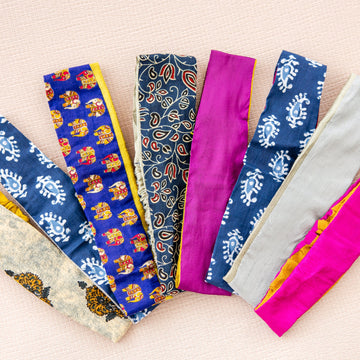 Colorful headbands with various patterns arranged on a beige background